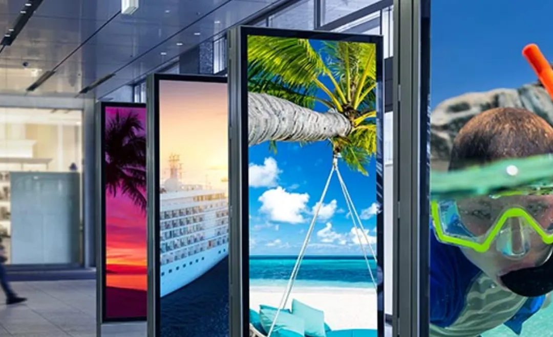 Tall screens in a shopping arcade showing holiday photos.