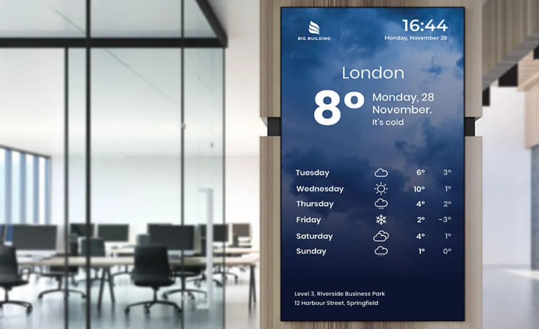 A tall screen with the weather and the week ahead in an office lobby.
